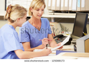 stock-photo-two-nurses-working-at-nurses-station-125088173